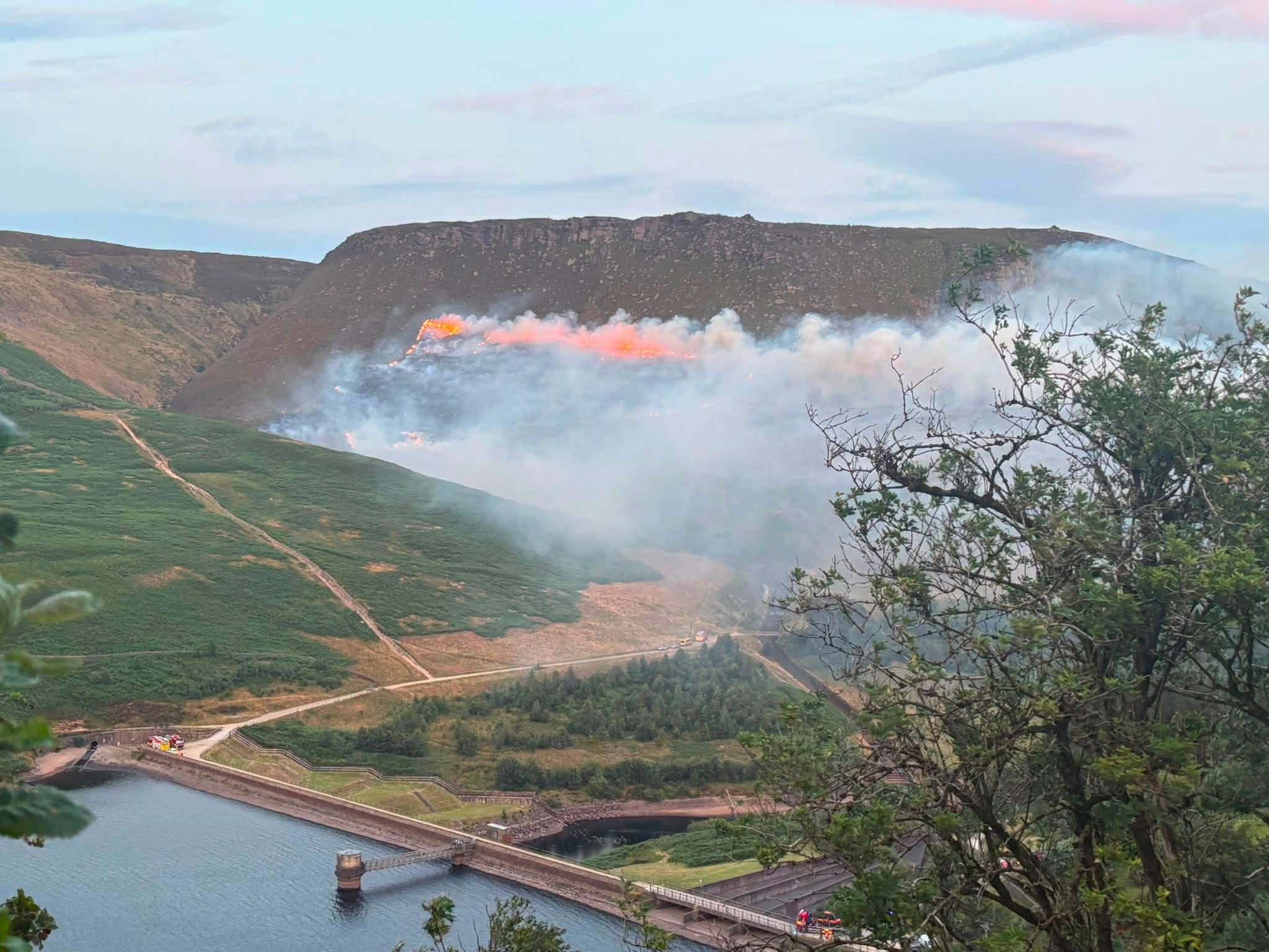 Crews battle day and night to stop a huge wildfire tearing across the tinder-dry Peak District - deep peat ignitions keep reigniting the blaze as it creeps towards homes near Carrbrook.