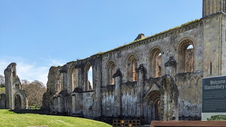 An abbot's kneecap pinched from an opened tomb by an 11-year-old boy on a 1956 school trip has been returned to Glastonbury Abbey over 70 years later.