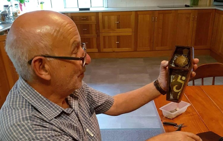 An abbot's kneecap pinched from an opened tomb by an 11-year-old boy on a 1956 school trip has been returned to Glastonbury Abbey over 70 years later.