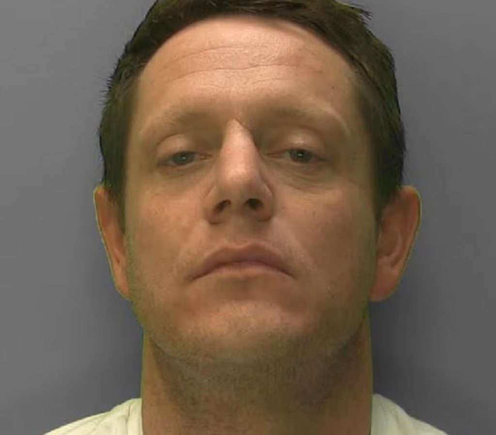 A man jailed for a balaclava-clad wrench attack on a father at his home is now on the run - and police are warning the public not to approach him.