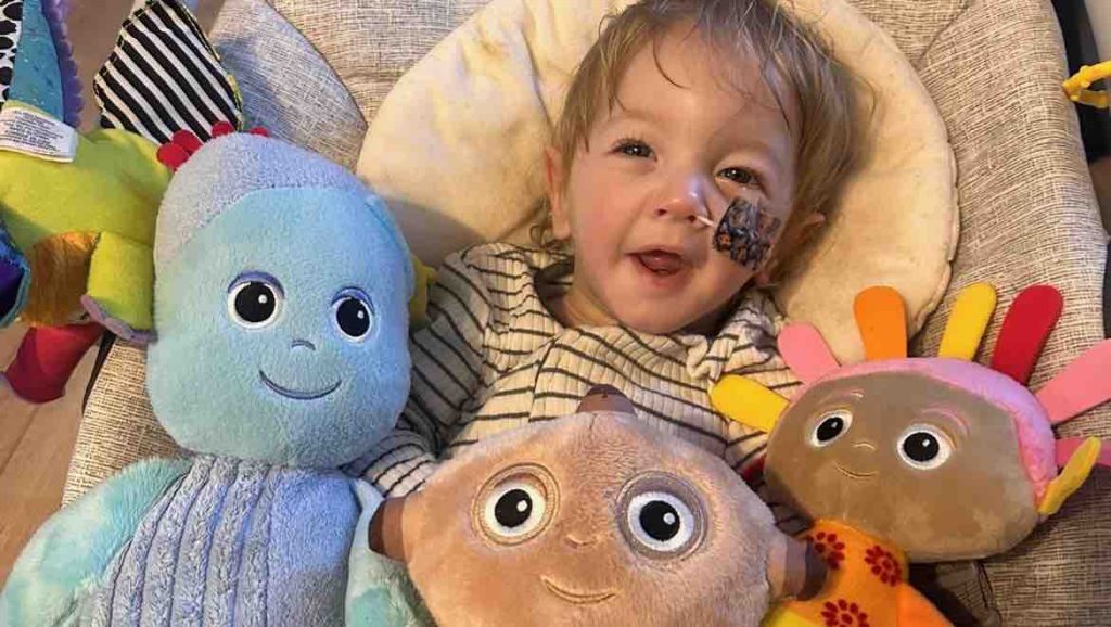 British toddler with the 'biggest grin' dies aged one after a lifelong fight with a rare brain condition - his heartbroken parents pay tribute.