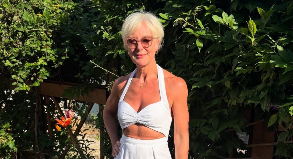 A fashion boss branded an inappropriate granny for refusing to cover up has welcomed her first grandchild - but says she won't be swapping corsets for cardigans.