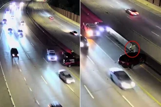A pedestrian cheated death by leaping onto a motorway barrier just seconds before an out-of-control car smashed into their stranded vehicle on a busy US interstate.