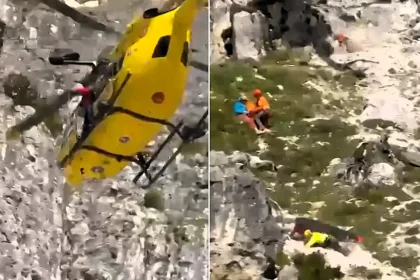 Shocking footage shows a rescue doctor stumbling and tumbling down a rocky mountainside alongside her stretcher - while trying to save a stranded climber.