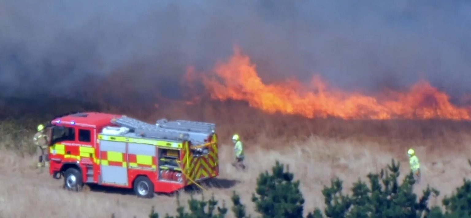 A golf club in a Cornish village dubbed 'Hollywood-on-Sea' has been threatened by wildfire flames sparked by a tractor hitting a stone while topping a field.
