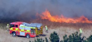A golf club in a Cornish village dubbed 'Hollywood-on-Sea' has been threatened by wildfire flames sparked by a tractor hitting a stone while topping a field.