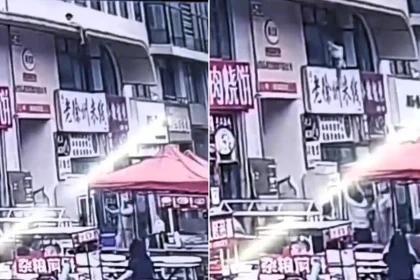 A hero passer-by caught a two-year-old girl with his bare hands as she plunged 20ft from a ledge in China - she escaped with just a fractured ankle.