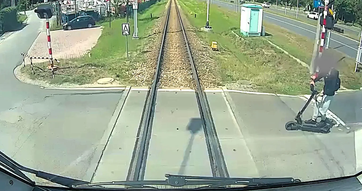 An e-scooter rider, 16, was seriously injured after ignoring flashing red lights at a level crossing and ploughing straight into the side of a speeding train.