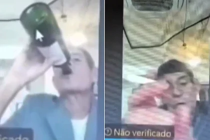 A senior judge has been suspended after being filmed necking wine straight from the bottle and lighting a cigarette with a blowtorch during a live hearing.