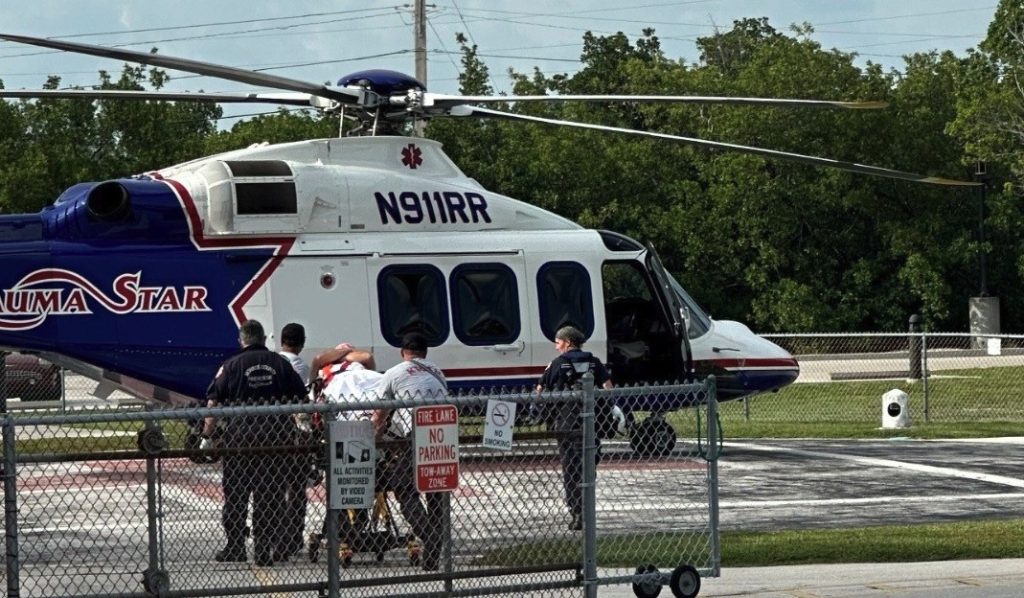 A fisherman bitten by a seven-foot shark was saved from bleeding to death by two nurses on a nearby boat - after fearing he would die on a sandbar.