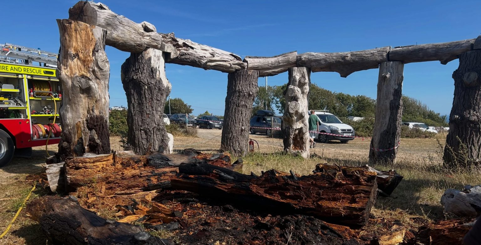 A Stonehenge copycat known as 'Woodhenge' has been engulfed by flames and destroyed as the UK battles 'scorched Earth' conditions, standing over a decade.