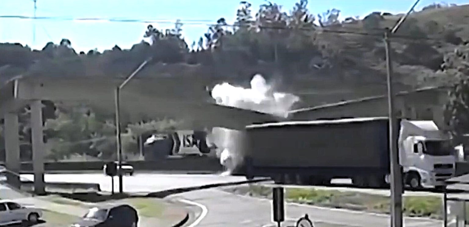 A mother and her son were killed when a lorry struck a motorway footbridge on a Brazilian highway - sending the structure crashing down and crushing their car beneath it.