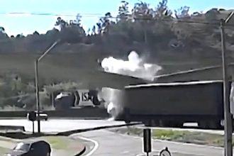 A mother and her son were killed when a lorry struck a motorway footbridge on a Brazilian highway - sending the structure crashing down and crushing their car beneath it.