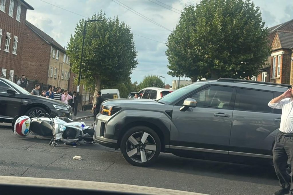 This is the shocking moment a motorcyclist flips head-first over a £40,000 car in a head-on smash - before jumping up and sprinting off, leaving a shoe behind.