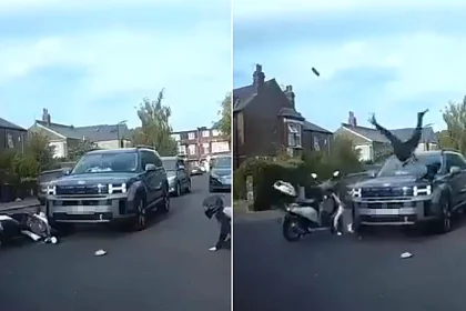 This is the shocking moment a motorcyclist flips head-first over a £40,000 car in a head-on smash - before jumping up and sprinting off, leaving a shoe behind.