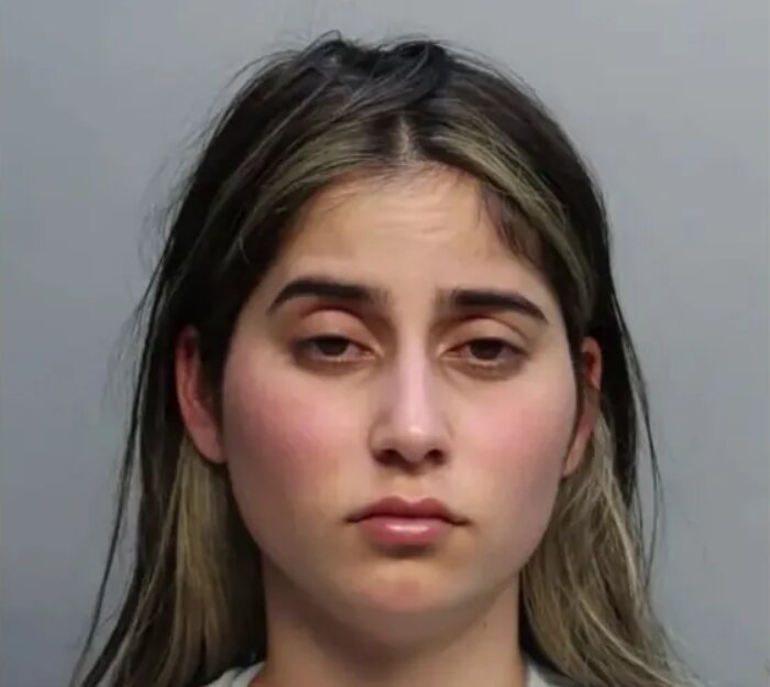 A mum has been arrested after videos allegedly showed her pouring melted candle wax onto her young daughters and setting fire to clothing inside their home.