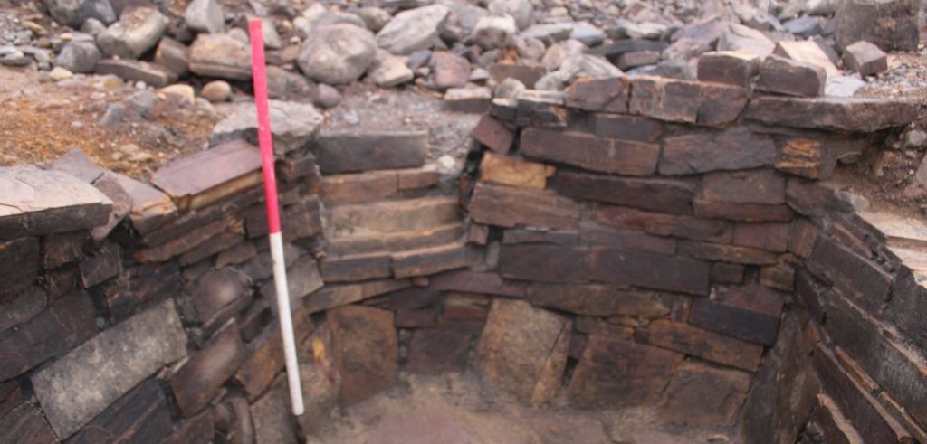 Archaeologists have unearthed a mysterious 2,000-year-old Iron Age pit holding a woman's skeleton - with one expert joking it could have been an ancient hot tub.