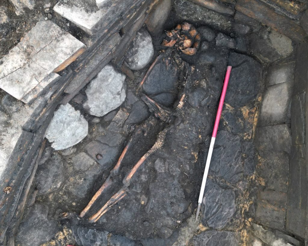 Archaeologists have unearthed a mysterious 2,000-year-old Iron Age pit holding a woman's skeleton - with one expert joking it could have been an ancient hot tub.