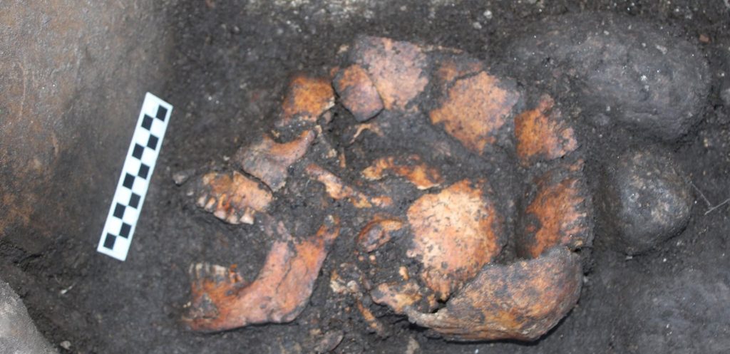 Archaeologists have unearthed a mysterious 2,000-year-old Iron Age pit holding a woman's skeleton - with one expert joking it could have been an ancient hot tub.