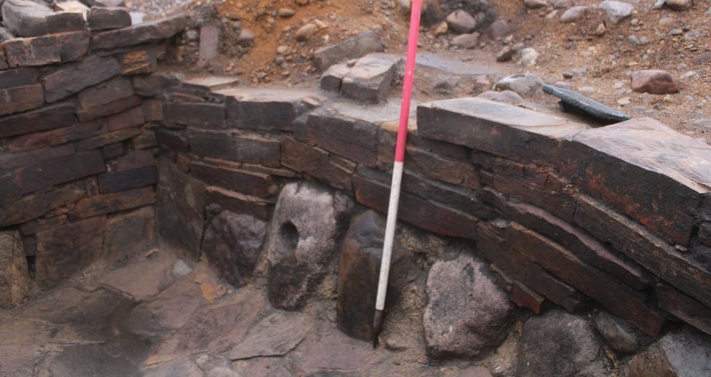 Archaeologists have unearthed a mysterious 2,000-year-old Iron Age pit holding a woman's skeleton - with one expert joking it could have been an ancient hot tub.