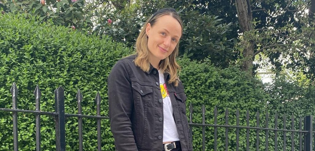 A champion boxer has flown home to the UK after suffering a bleed on the brain during sparring - with fans raising more than £97,000 to bring her back.