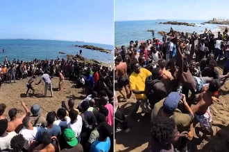 Scores of migrants have been filmed holding a bizarre wrestling contest on a Spanish beach in Ceuta - weeks after a mass rush at the border.