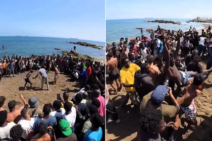 Scores of migrants have been filmed holding a bizarre wrestling contest on a Spanish beach in Ceuta - weeks after a mass rush at the border.