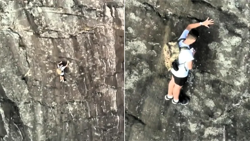 Climber branded 'stupid' after being filmed on his phone while stranded 260ft up a mountain on a ledge just 20 inches wide.