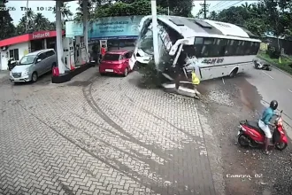 Dramatic CCTV shows a wedding party's bus swerving to avoid a scooter before rolling onto its side at a petrol station - stopping just short of the fuel pumps.