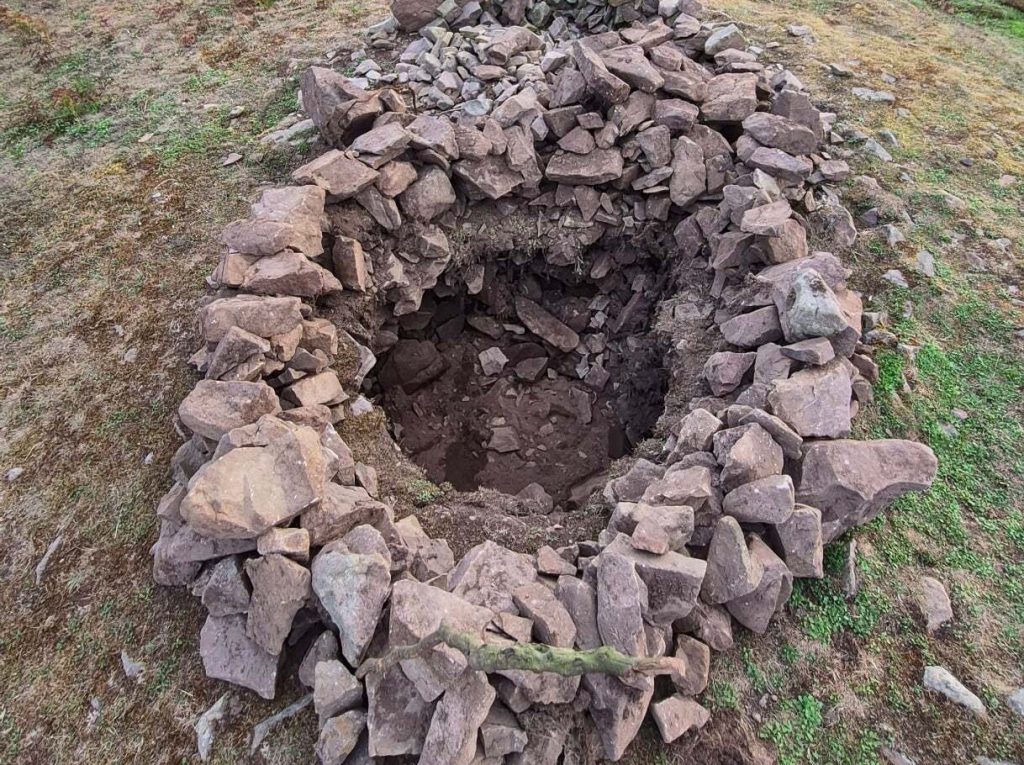 A 4,000-year-old Bronze Age burial mound has been vandalised after rocks were removed from the protected site - just two years after it was last repaired.