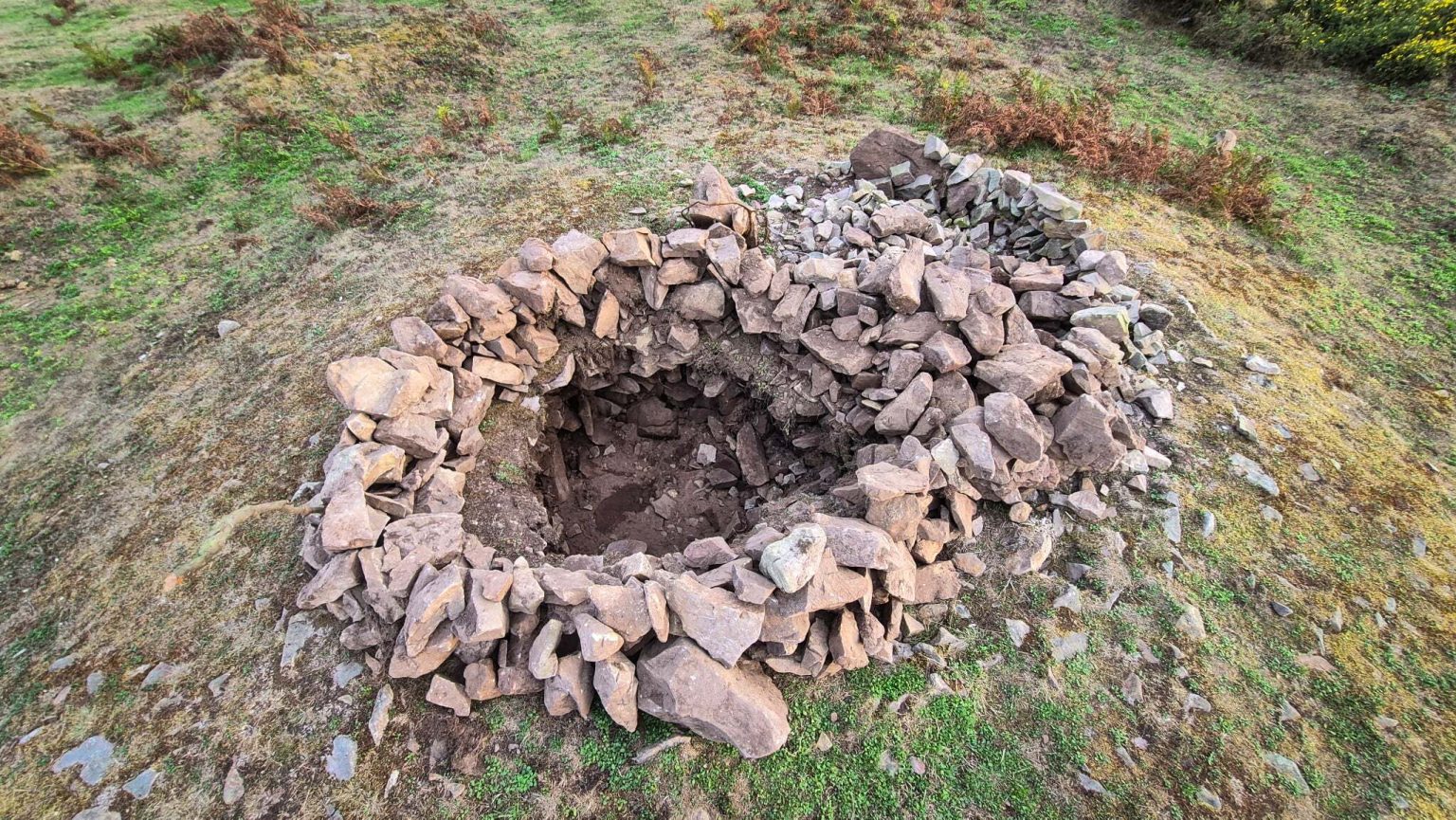 A 4,000-year-old Bronze Age burial mound has been vandalised after rocks were removed from the protected site - just two years after it was last repaired.