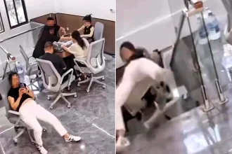 A bored office worker was filmed tumbling down a flight of stairs in her chair while glued to her phone - and didn't look up until she'd already gone over.