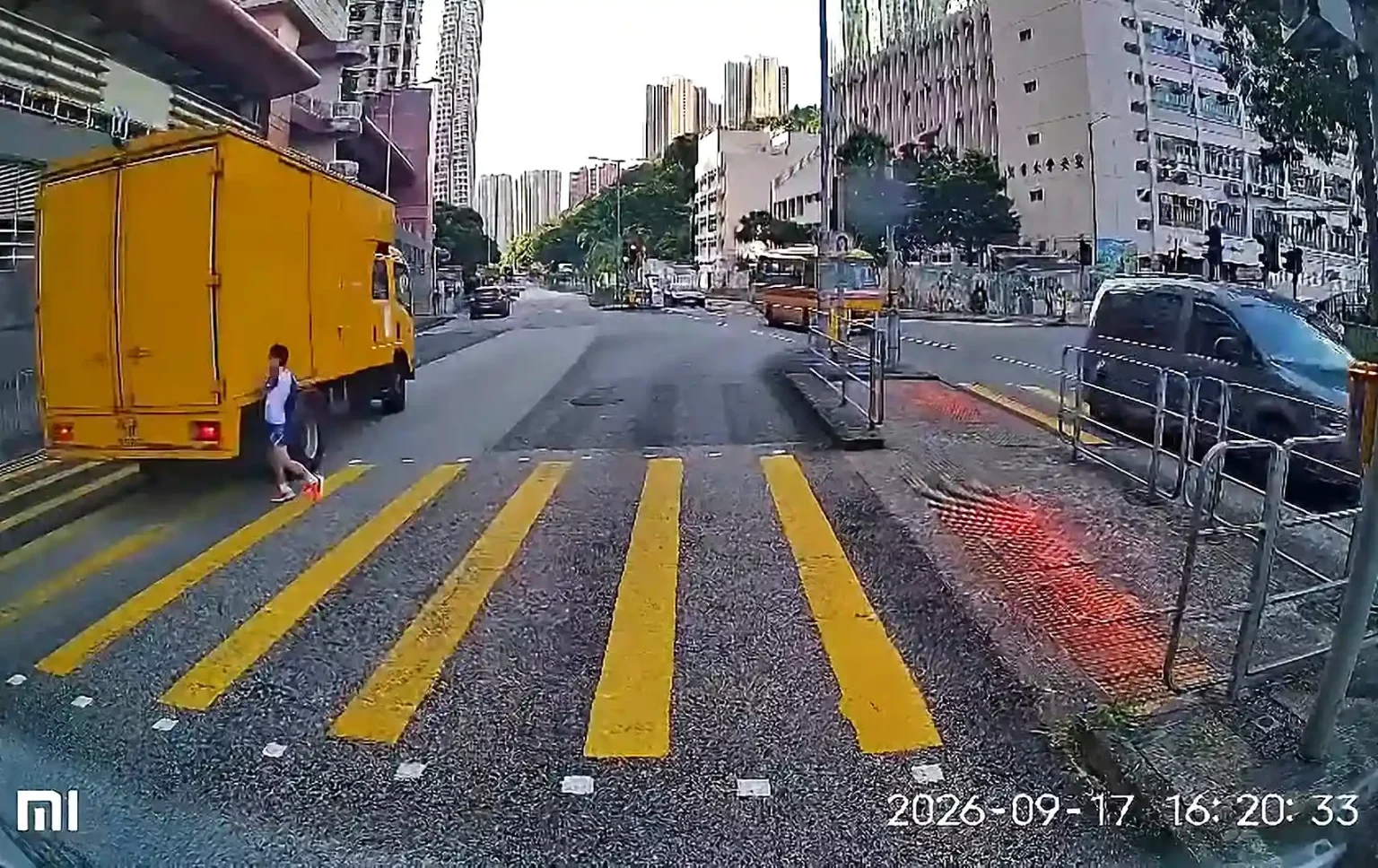 Dashcam footage shows the terrifying moment a nine-year-old boy sprints across five lanes of traffic in Hong Kong on a red signal before being hit by a huge truck.