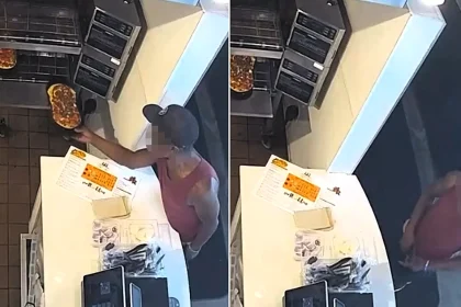 An alleged pizza thief grabbed a freshly cooked pizza straight from a restaurant oven with his bare hands - CCTV shows him recoiling as the piping-hot tray burns him.