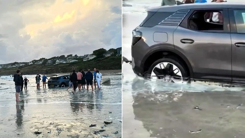 A car was left stranded on a Cornish beach with its wheels buried in sand as the tide crept in - and onlookers joked it should be put in a bowl of rice.