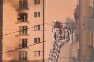 Shocking footage shows a father and son clinging to a razor-thin ledge above a dizzying drop as smoke swallowed their 28-storey tower block.