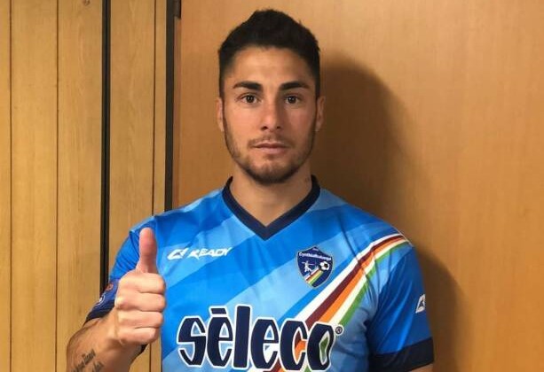 A footballer has been arrested after allegedly wrestling a police officer's gun away from her in the street - before the former River Plate star ran off with it.