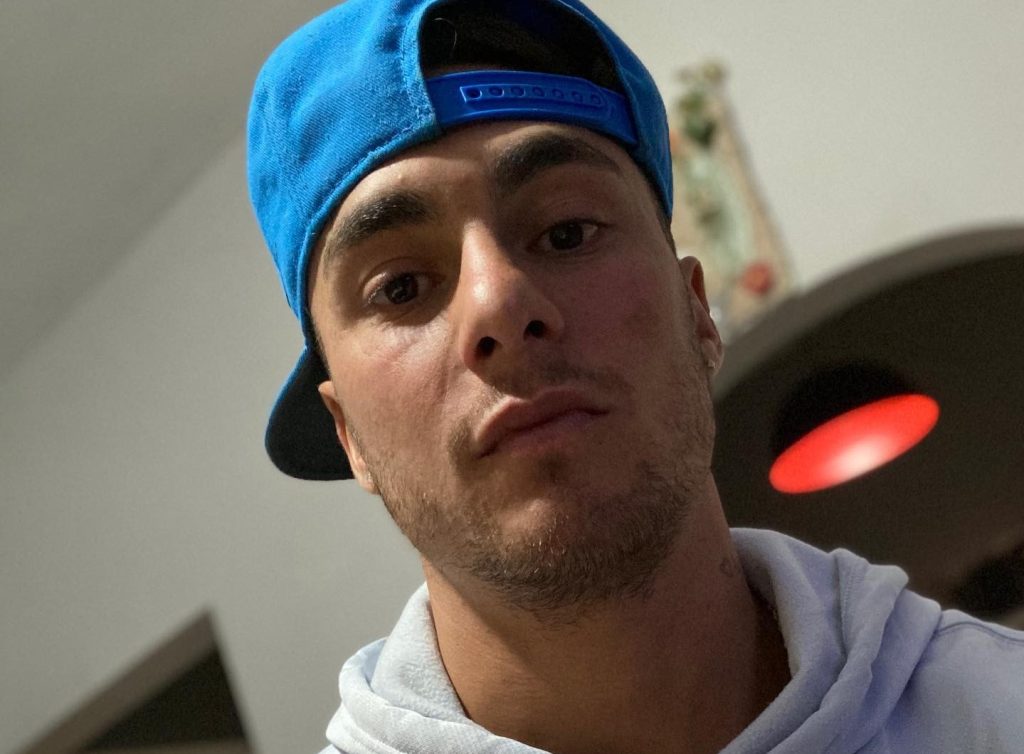 A footballer has been arrested after allegedly wrestling a police officer's gun away from her in the street - before the former River Plate star ran off with it.