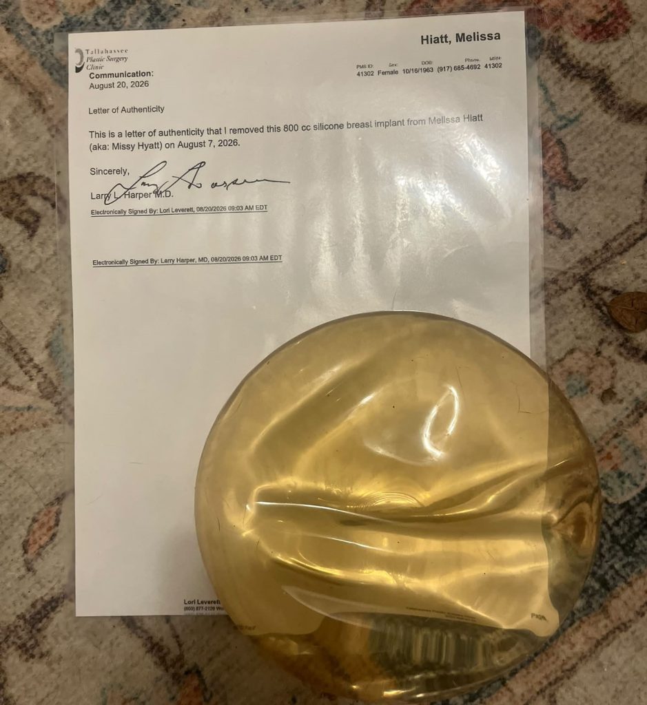 An ex-WWE legend is auctioning off one of her old breast implants for £1,000 - telling fans it is their chance to "hold" her, complete with a certificate.