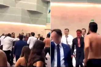 A graduation party descended into a mass brawl after students and their families began throwing punches, chairs and bottles - leaving one man's face covered in blood.