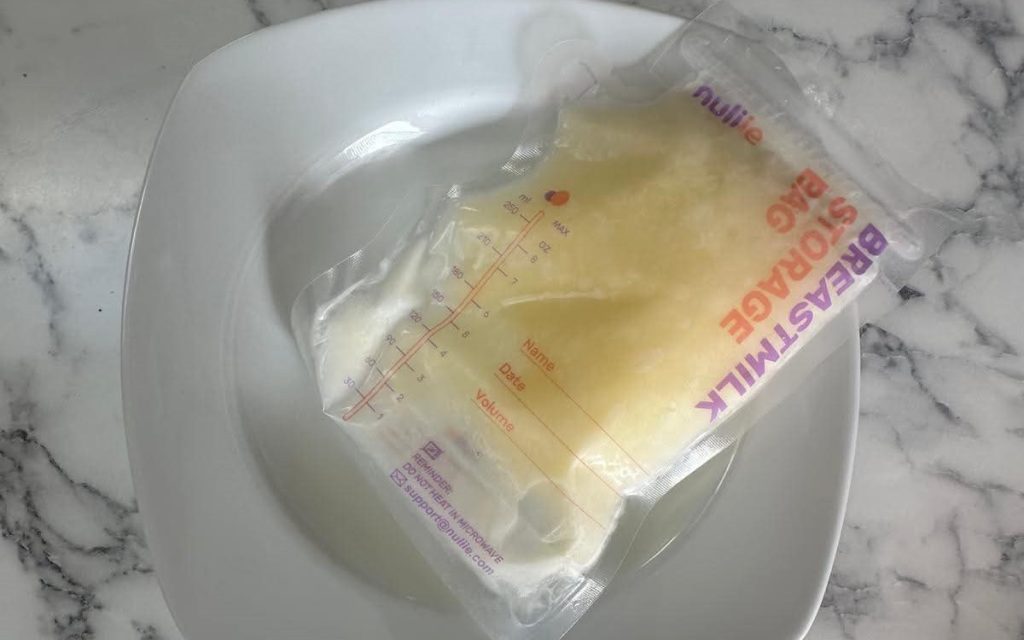 A mum given a 30% survival chance who lost her breasts to cancer says 20 strangers stepped in to feed her miracle IVF baby - her freezer is now overflowing.