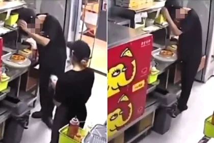 A pizza worker was caught on an open kitchen camera rubbing his scalp to shake dandruff onto a customer's order after a row - with colleagues chatting nearby.