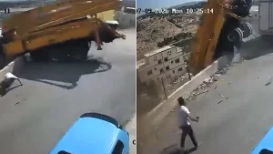 Dramatic CCTV shows a driver flinging himself from a runaway concrete pump truck moments before it smashed through a barrier and plunged into a ravine.
