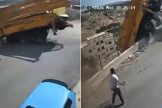 Dramatic CCTV shows a driver flinging himself from a runaway concrete pump truck moments before it smashed through a barrier and plunged into a ravine.
