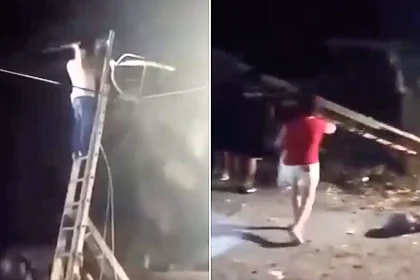 Terrifying footage shows a man plunging to the ground after his ladder slips while he saws a tree branch near overhead power lines in the dark.