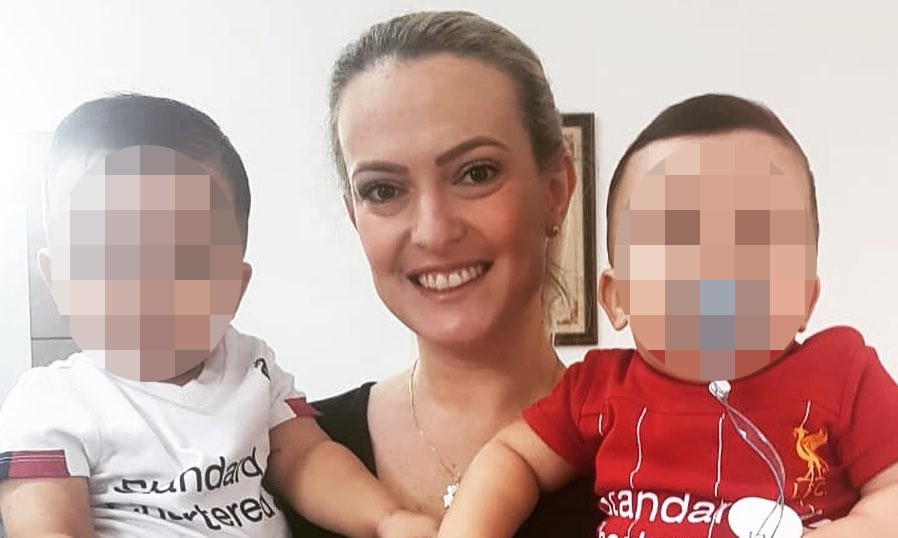 A man has been jailed for more than 13 years after stabbing his wife to death in front of their children during a row over rival football teams.