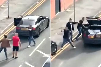 Shocking moment man swings a metal pole at a taxi during broad daylight street brawl in Stoke-on-Trent - as passenger inside is assaulted and police launch probe.