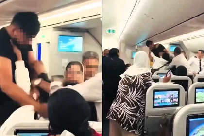 Shocking footage shows two passengers trading punches on a Biman Bangladesh Airlines flight to London - with one man's T-shirt ripped open in front of horrified families.