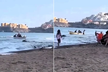 Sunseekers watched in shock as nine men leapt from a 'taxi boat' and waded ashore at an idyllic Spanish beach - as children played nearby.