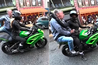 A biker whacked an "inappropriate" old man after he jumped onto her motorcycle and grabbed her hips while she sat in traffic - as his mates laughed.
